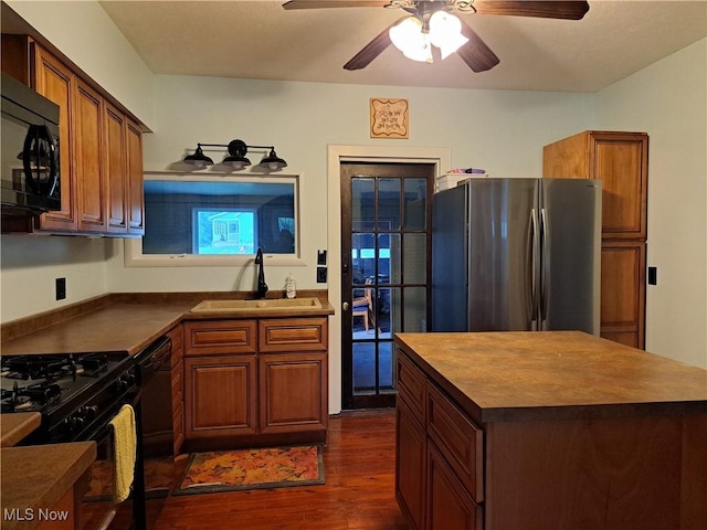 49197 John Tomcho Rd, Cumberland, OH 43732 - kitchen featuring black appliances, dark wood finished floors, a sink, and dark countertops