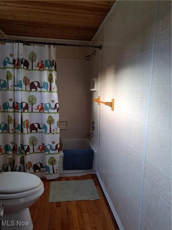 49197 John Tomcho Rd, Cumberland, OH 43732 - bathroom featuring wooden ceiling, curtained shower, wood finished floors, and toilet