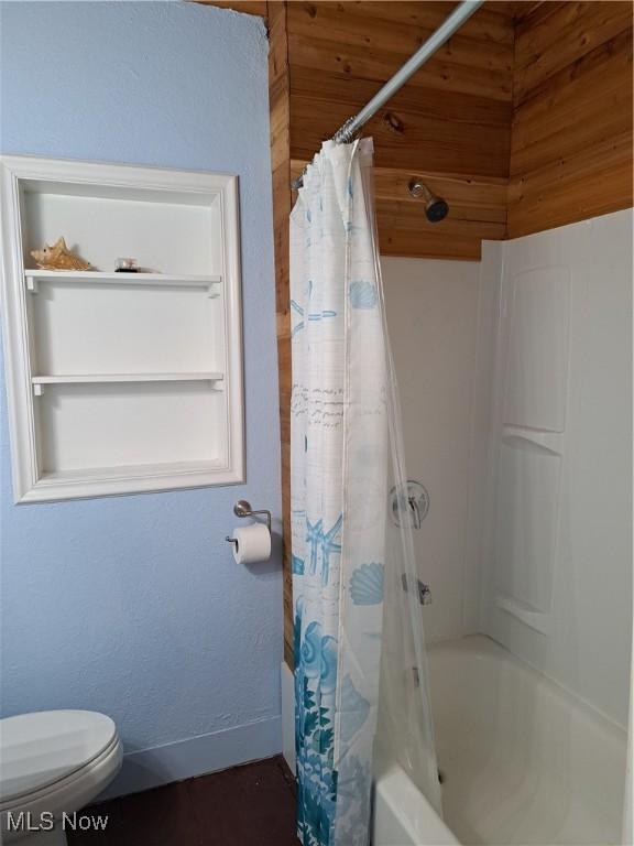 49197 John Tomcho Rd, Cumberland, OH 43732 - full bath featuring toilet, shower / tub combo, and baseboards