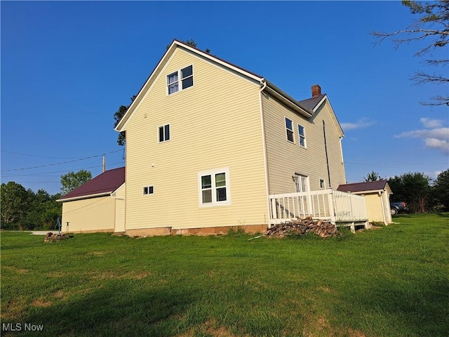 49197 John Tomcho Rd, Cumberland, OH 43732 - back of house with a chimney, a lawn, and a deck