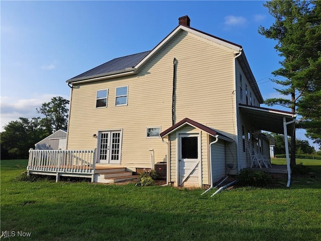 49197 John Tomcho Rd, Cumberland, OH 43732 - back of property with a chimney, a lawn, a deck, and french doors
