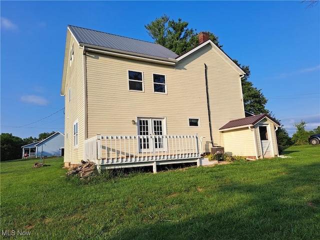 49197 John Tomcho Rd, Cumberland, OH 43732 - rear view of property with a lawn, a storage unit, an outbuilding, a chimney, and a deck