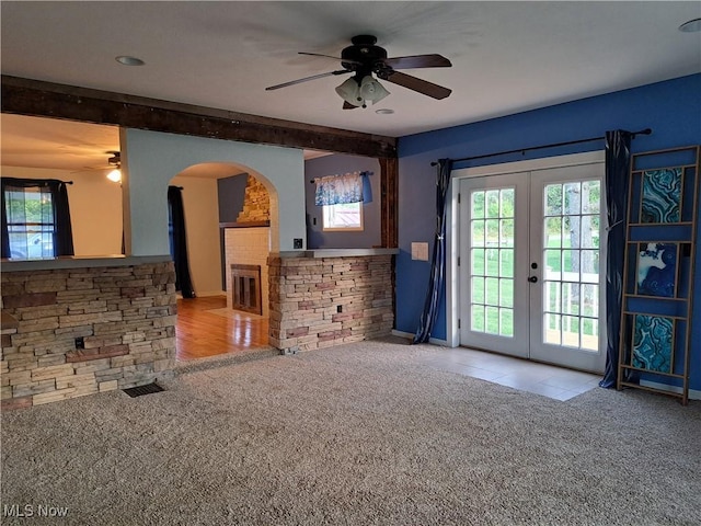 49197 John Tomcho Rd, Cumberland, OH 43732 - unfurnished living room with carpet floors, a ceiling fan, french doors, and beam ceiling
