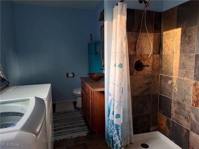 49197 John Tomcho Rd, Cumberland, OH 43732 - full bath with a tile shower, vanity, toilet, and washer / clothes dryer