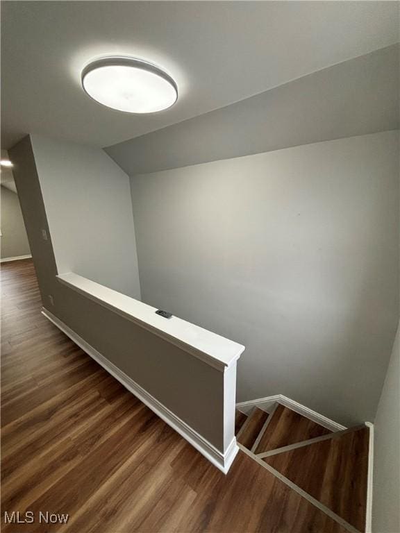 4399 W 57th St, Cleveland, OH 44144 - stairs featuring baseboards, wood finished floors, and vaulted ceiling