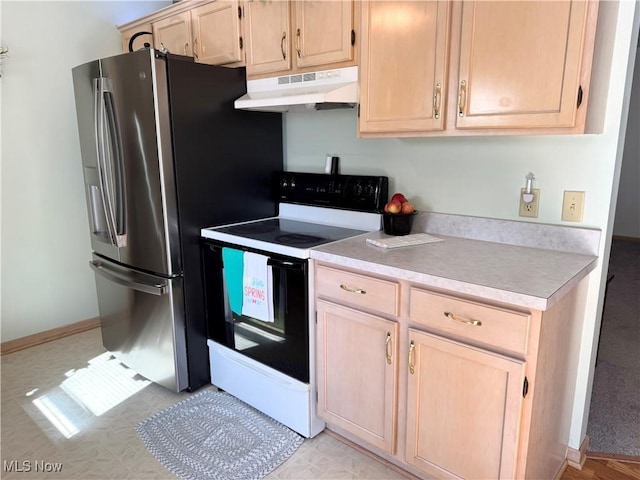 kitchen with light countertops, under cabinet range hood, light brown cabinetry, electric stove, and stainless steel fridge