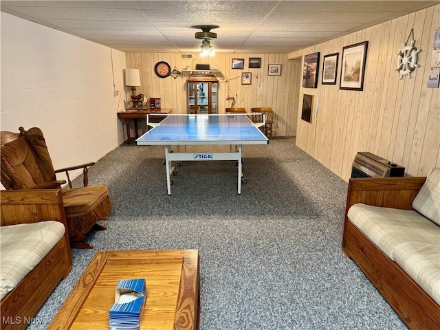 game room with wooden walls and carpet