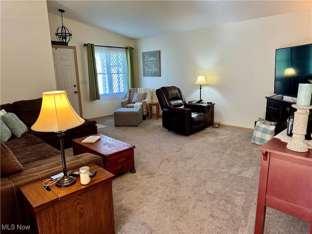 living area featuring baseboards, lofted ceiling, and carpet