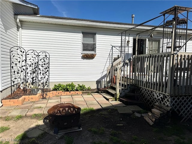 exterior space featuring a fire pit and a deck