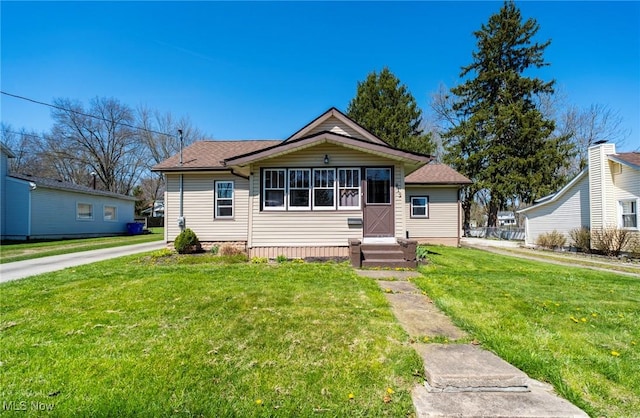 bungalow-style house with a front yard