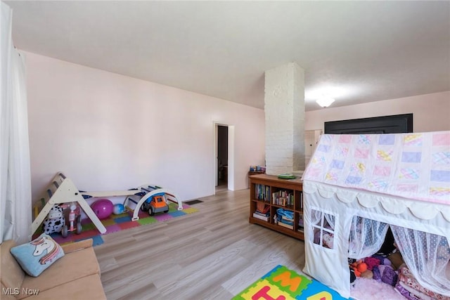 bedroom featuring visible vents and wood finished floors