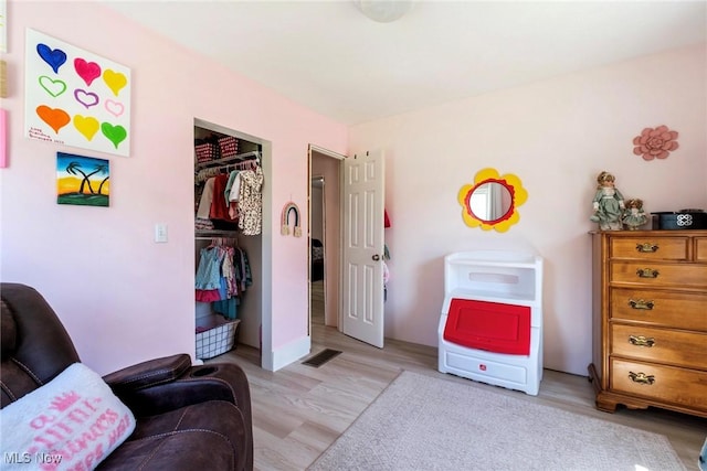 sitting room featuring visible vents and light wood-style flooring