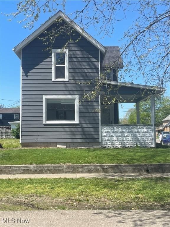 353 N 11th St, Coshocton, OH 43812 - view of side of property featuring a lawn