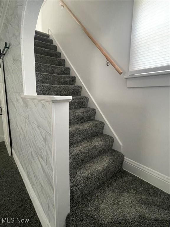 353 N 11th St, Coshocton, OH 43812 - staircase featuring carpet floors, baseboards, and arched walkways