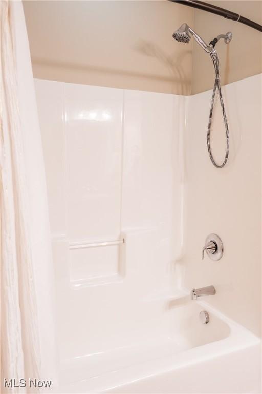 full bath featuring shower / bath combination with curtain