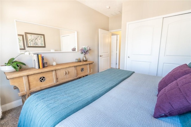 bedroom featuring baseboards, carpet floors, and a closet