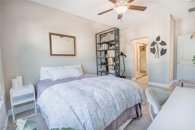 bedroom with a ceiling fan, visible vents, light carpet, baseboards, and ensuite bathroom