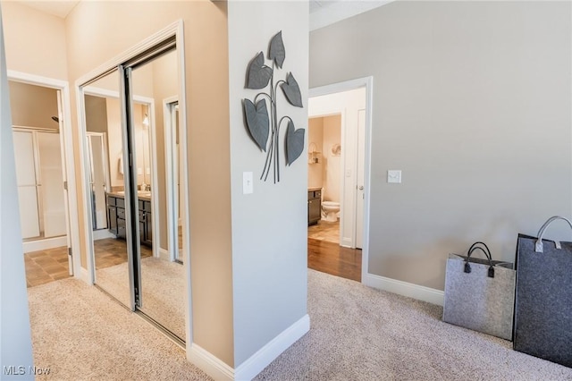 hall with carpet flooring and baseboards