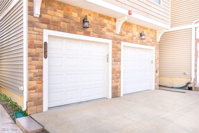 garage with concrete driveway