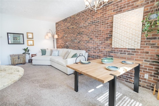 carpeted living room with a chandelier and brick wall