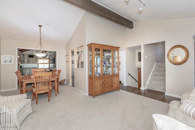 living room featuring stairs, carpet flooring, vaulted ceiling with beams, and baseboards