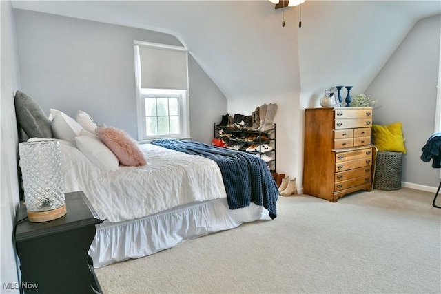 bedroom featuring lofted ceiling, a ceiling fan, and carpet flooring