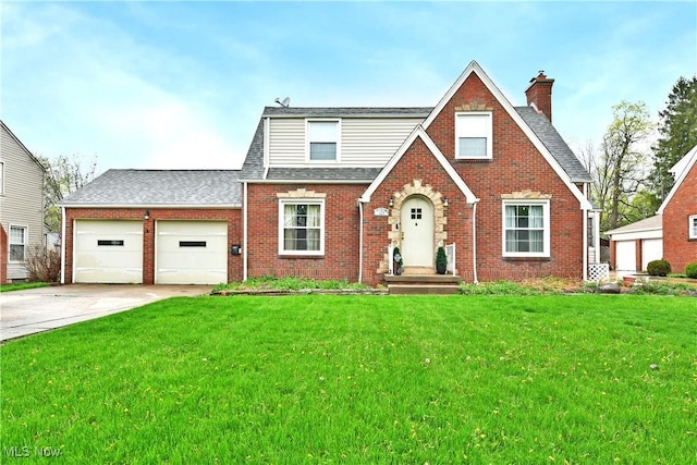 english style home with concrete driveway, a chimney, a front yard, brick siding, and a garage