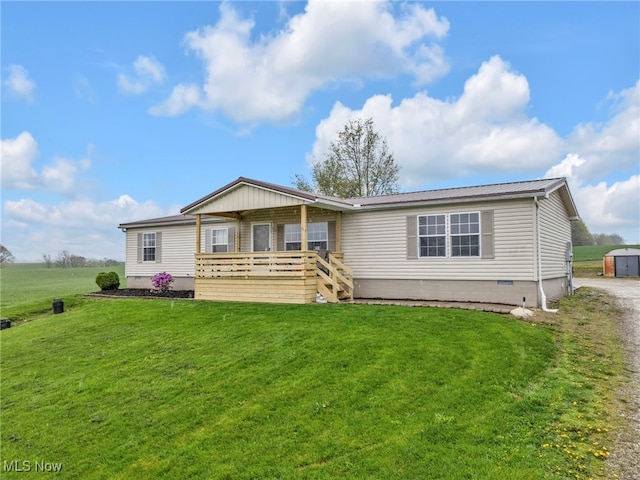 manufactured / mobile home with metal roof, a front yard, crawl space, and a wooden deck