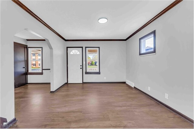 135 W Bagley Rd, Berea, OH 44017 - foyer featuring wood finished floors, baseboards, ornamental molding, and arched walkways