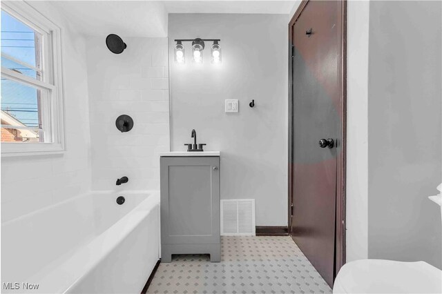 135 W Bagley Rd, Berea, OH 44017 - bathroom featuring a sink, washtub / shower combination, tile patterned floors, toilet, and visible vents