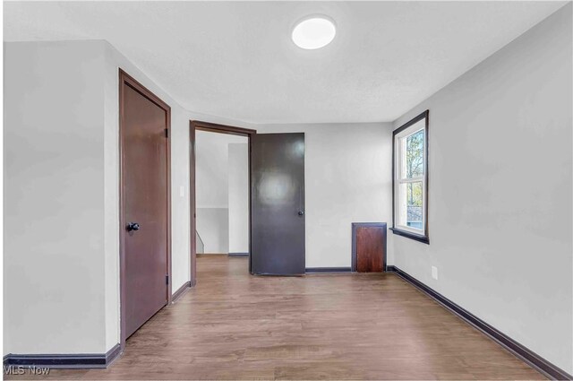 135 W Bagley Rd, Berea, OH 44017 - unfurnished bedroom with wood finished floors and baseboards