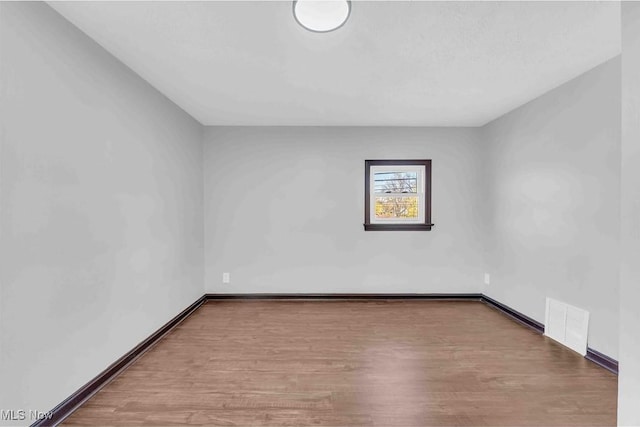 135 W Bagley Rd, Berea, OH 44017 - empty room with baseboards, visible vents, and wood finished floors