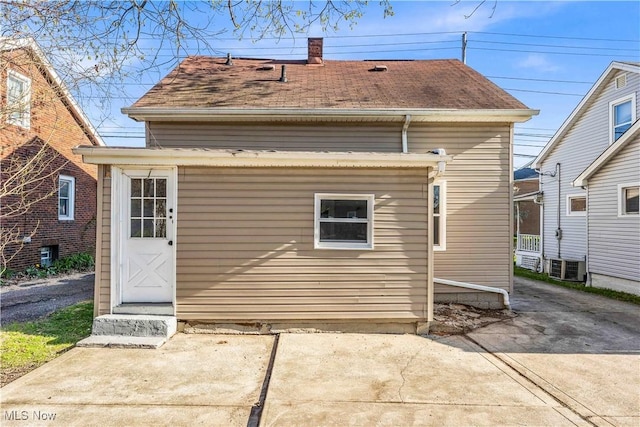 135 W Bagley Rd, Berea, OH 44017 - rear view of property featuring a chimney, a shingled roof, and central AC unit