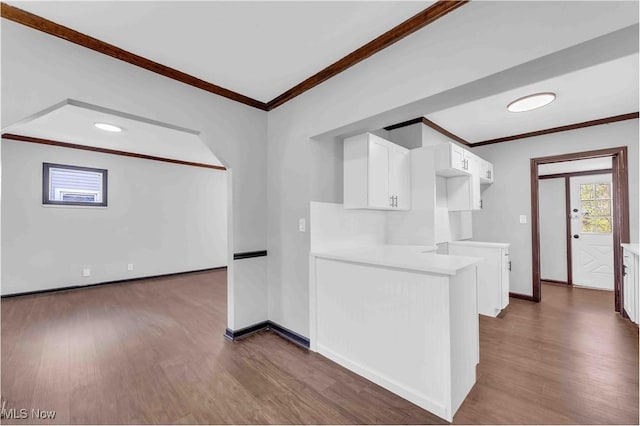 135 W Bagley Rd, Berea, OH 44017 - kitchen featuring dark wood-type flooring, ornamental molding, white cabinets, and baseboards