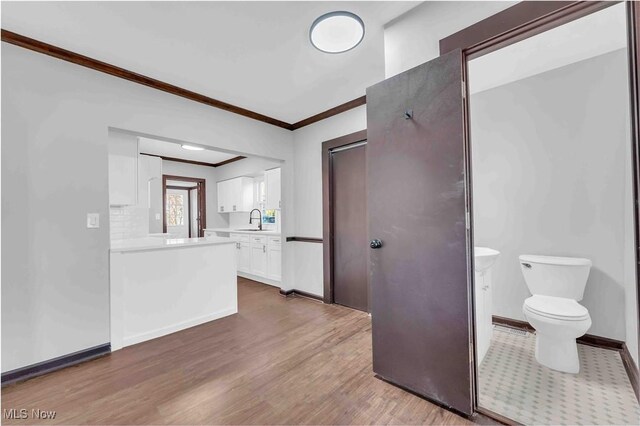 135 W Bagley Rd, Berea, OH 44017 - bathroom featuring vanity, toilet, baseboards, ornamental molding, and wood finished floors