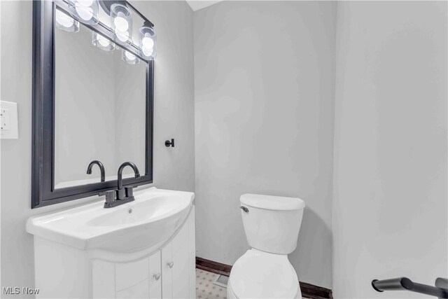 135 W Bagley Rd, Berea, OH 44017 - bathroom featuring toilet, vanity, and baseboards