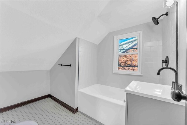 135 W Bagley Rd, Berea, OH 44017 - full bathroom with a bathing tub, a sink, a shower, baseboards, and vaulted ceiling