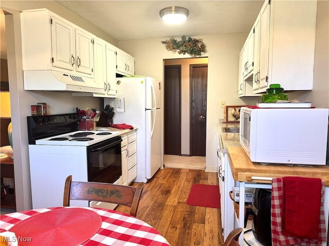 kitchen featuring white cabinetry, light countertops, under cabinet range hood, wood finished floors, and white appliances