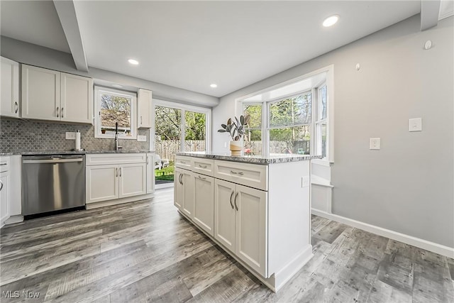 kitchen with tasteful backsplash, recessed lighting, dishwasher, and light wood finished floors