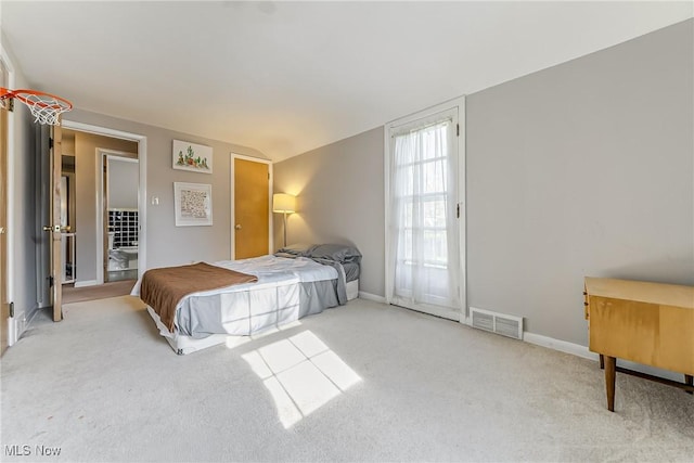 bedroom with visible vents, baseboards, vaulted ceiling, and carpet floors