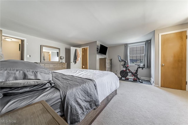 carpeted bedroom featuring baseboards