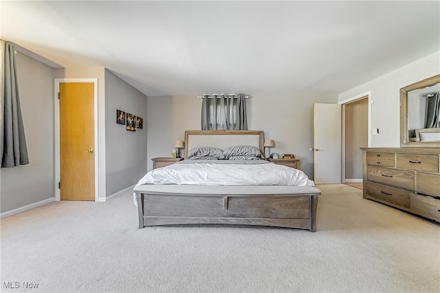 bedroom featuring baseboards and light carpet