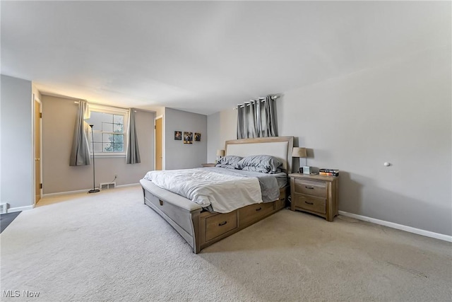 carpeted bedroom with visible vents and baseboards