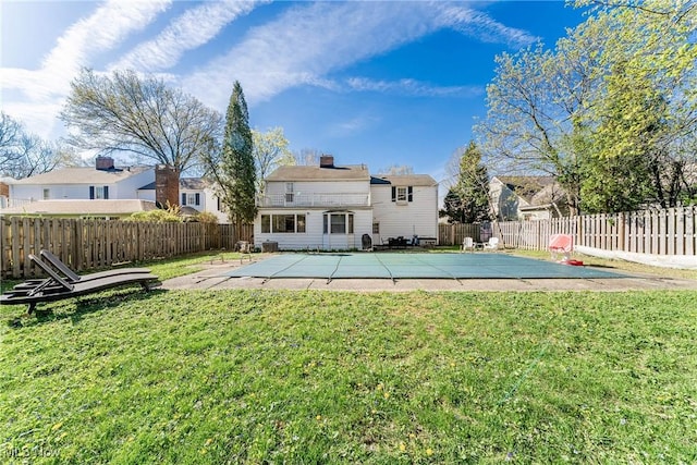 back of house with a lawn, a fenced backyard, and a patio area