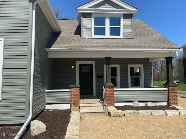 view of front of home featuring a porch and a shingled roof