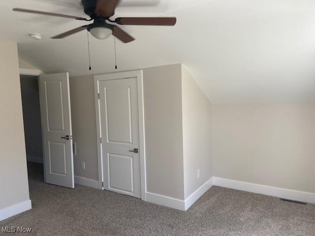 additional living space featuring baseboards, ceiling fan, carpet floors, and vaulted ceiling