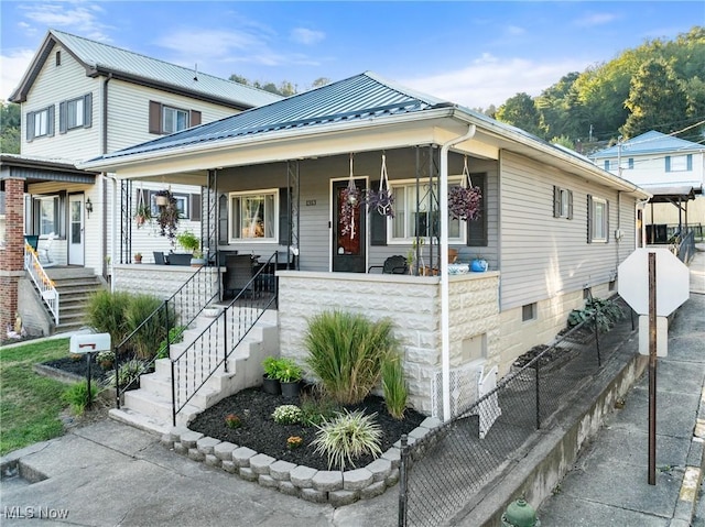 view of front facade with a porch and metal roof