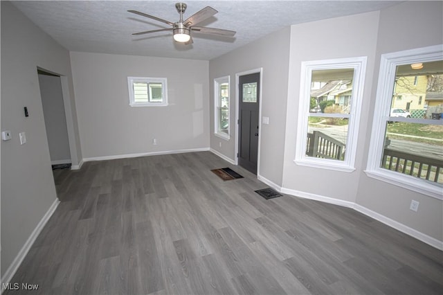 entrance foyer with a textured ceiling, wood finished floors, and a ceiling fan