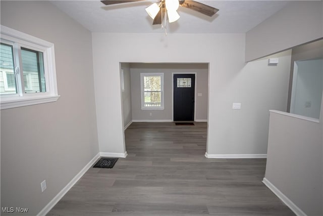 foyer entrance featuring visible vents, ceiling fan, wood finished floors, and baseboards