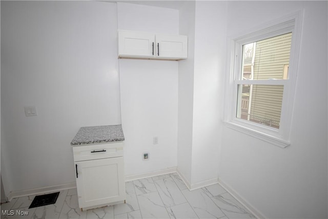 interior space with baseboards and visible vents
